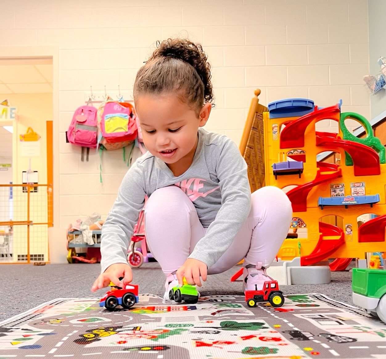 A child plays with toy cars.