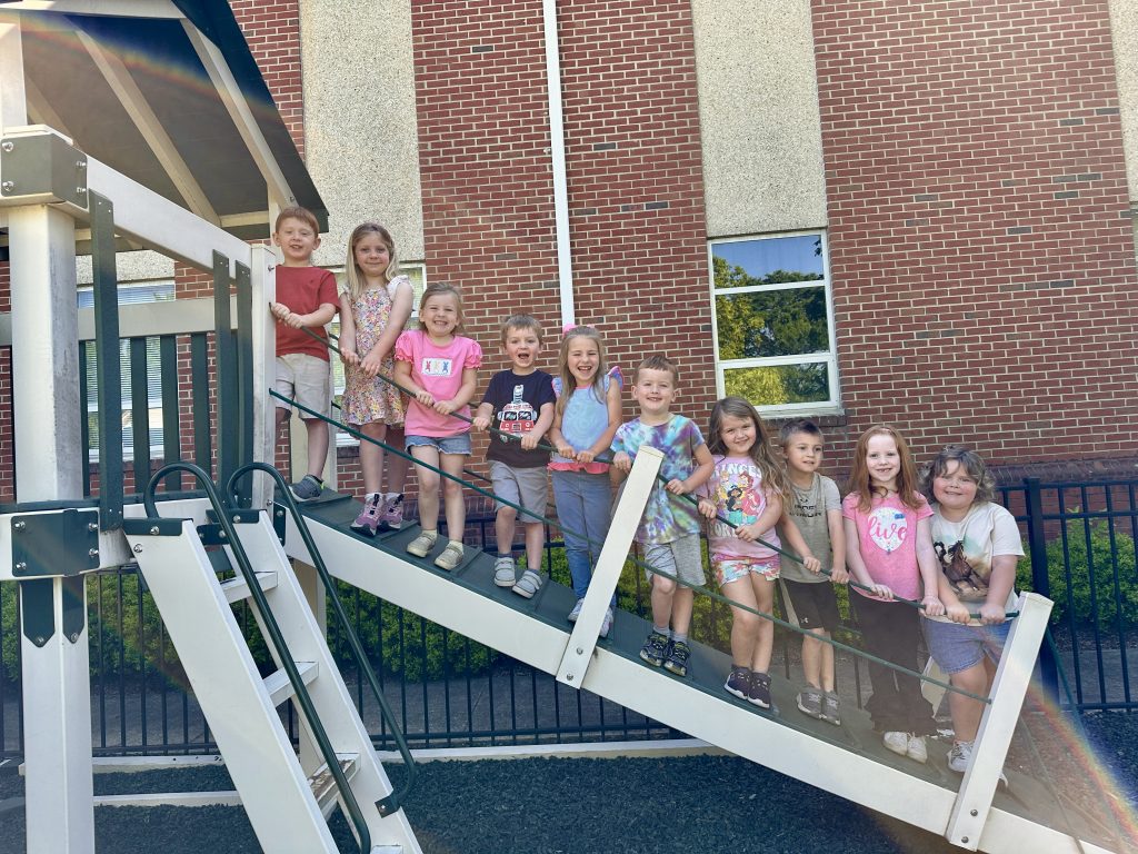 Children pose for a photo on the school playground.